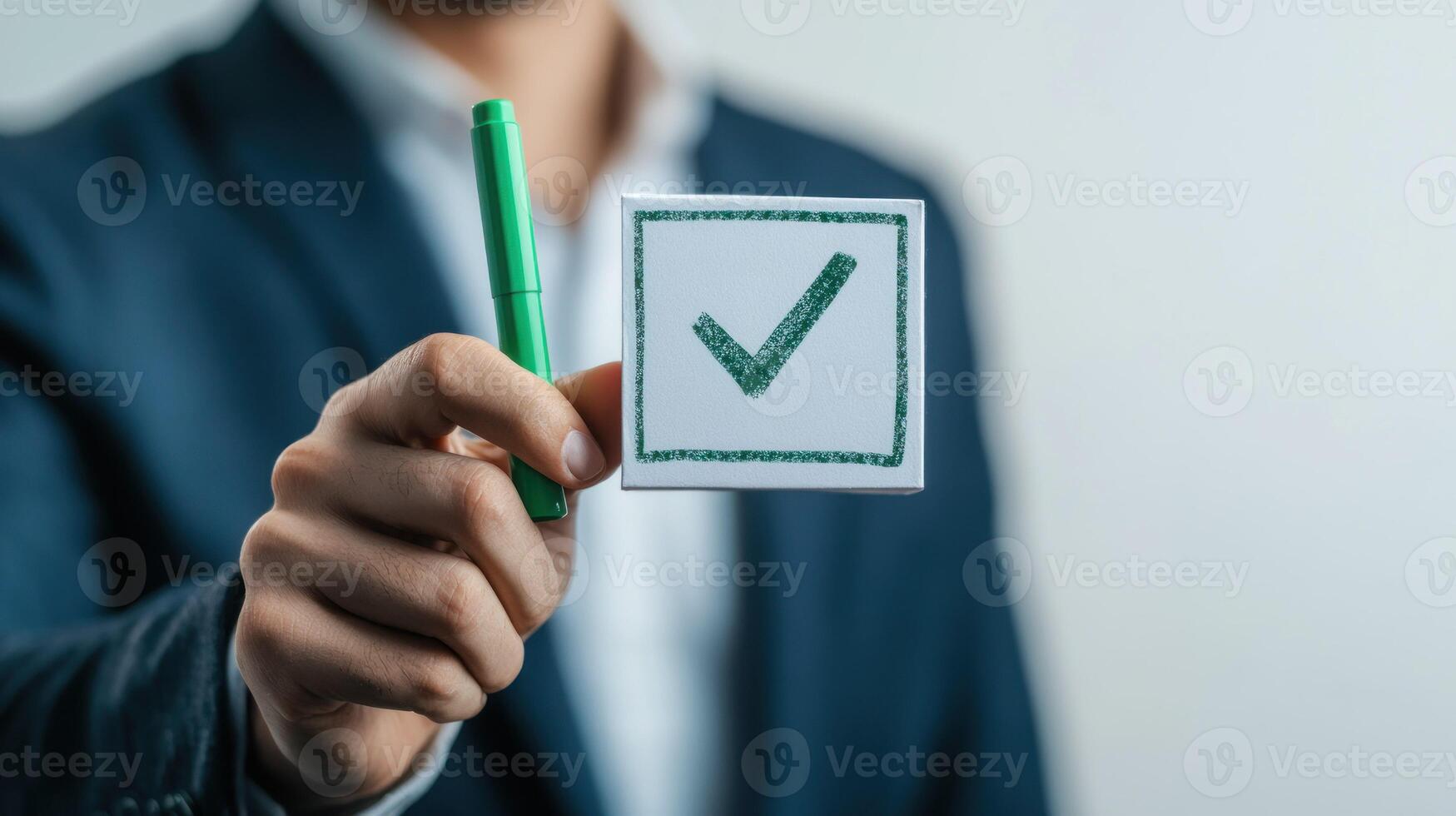 Person Holding a Check Mark on a White Card with a Green Marker photo