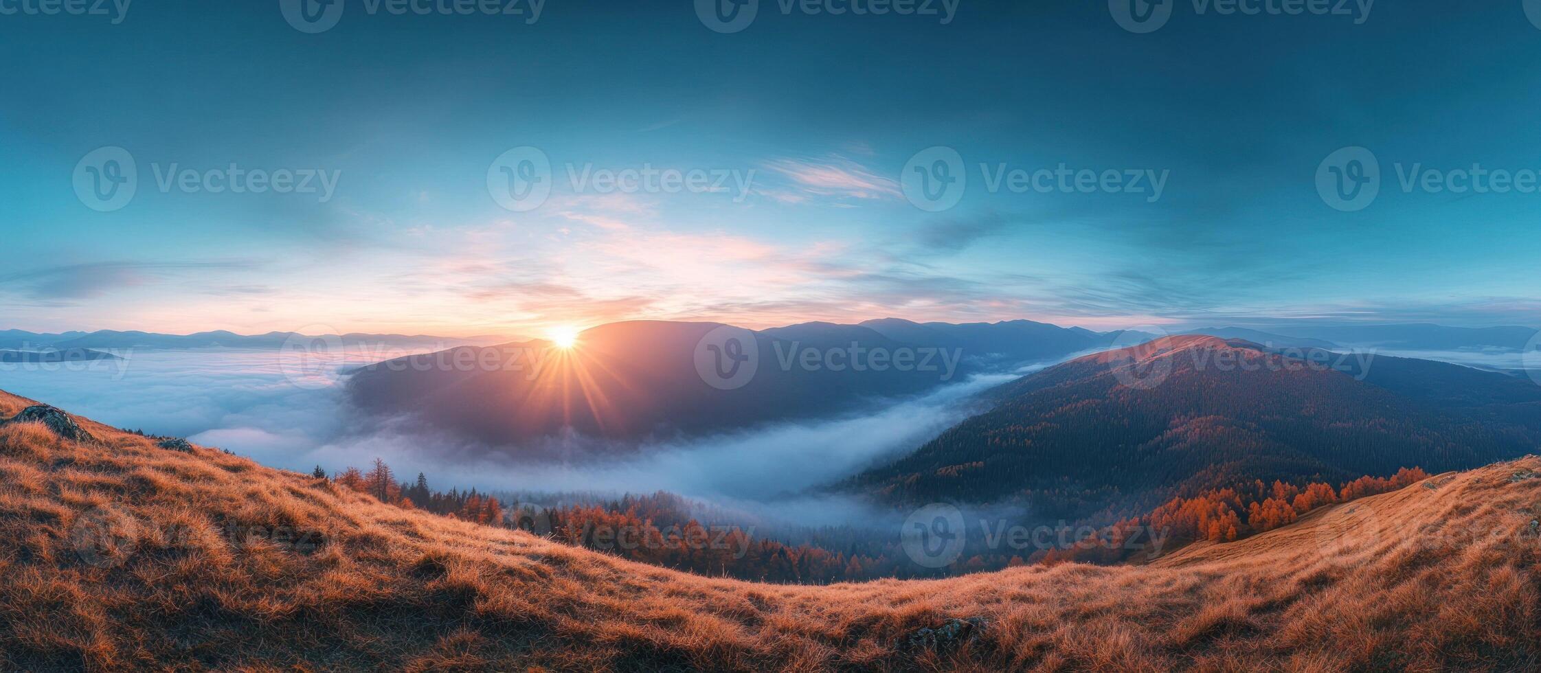 Golden Grass Hilltop Overlooking Misty Mountain Valley at Sunrise photo