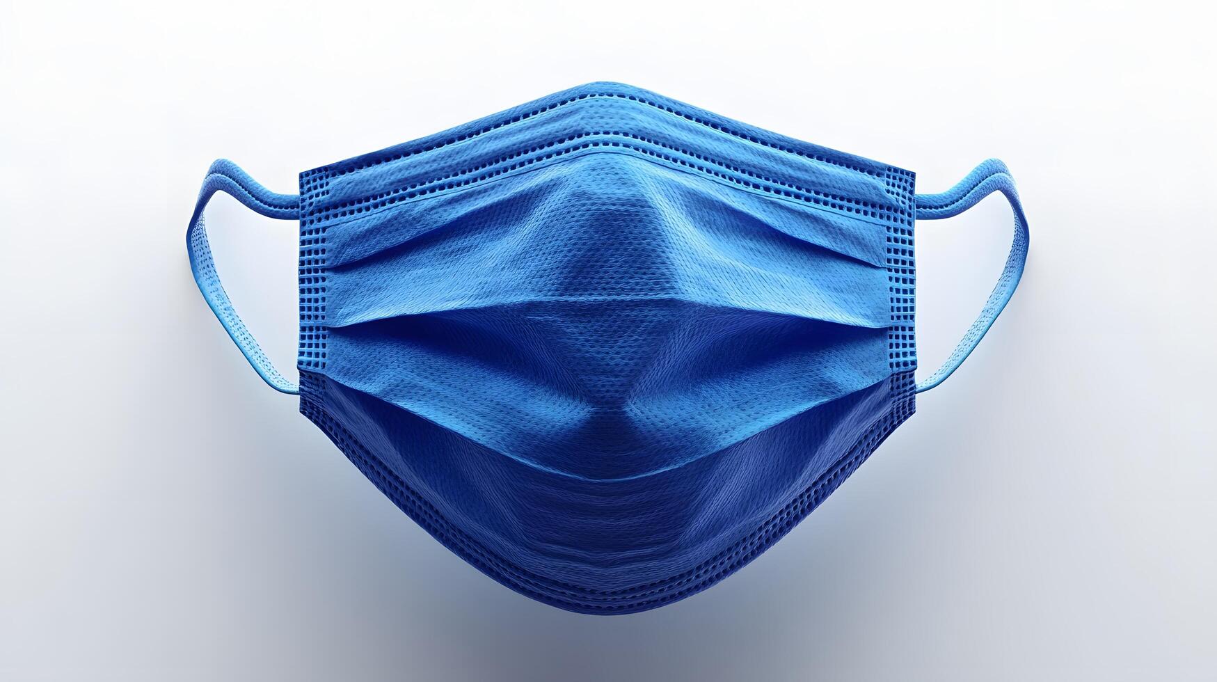 Simple blue surgical mask illustration floats against pure white background. Clean design emphasizes medical protection with subtle shadow beneath disposable face covering. essential photo