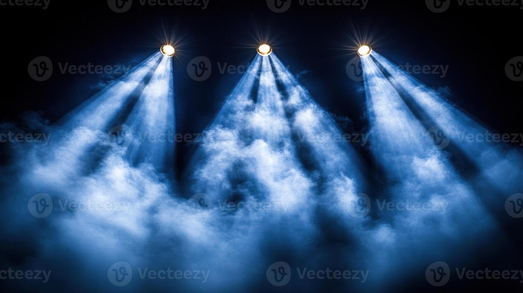 Brilliant beams of blue light pierce through thick fog, creating an enchanting atmosphere photo