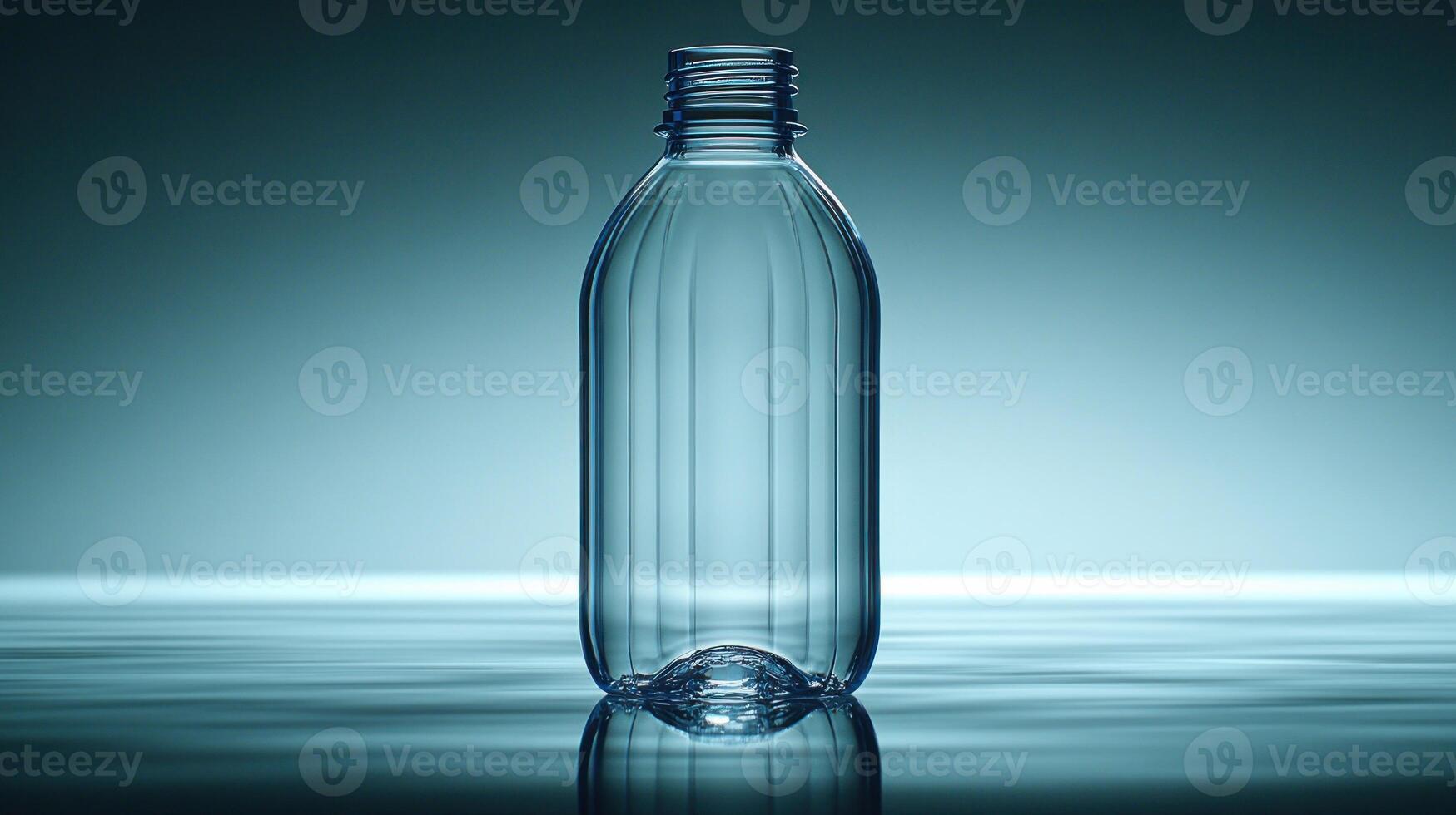 A clear bottle stands elegantly, reflecting ambient light on water's surface photo