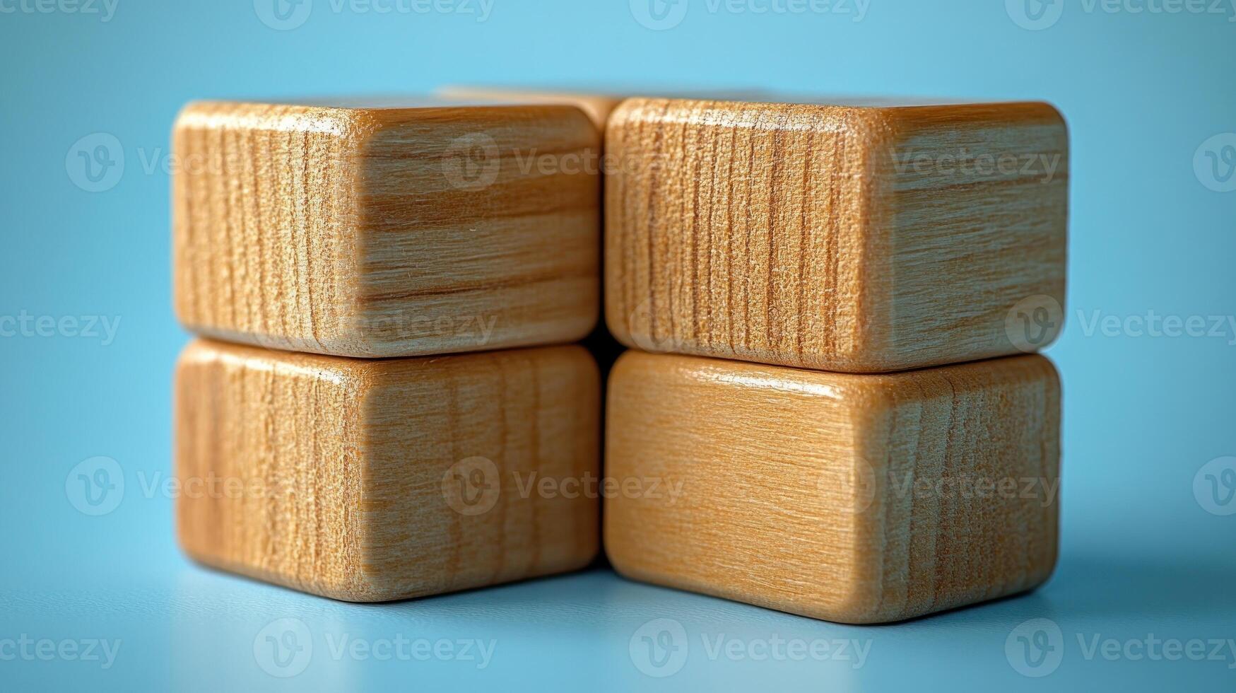 Natural wooden blocks arranged playfully on a soft blue surface photo