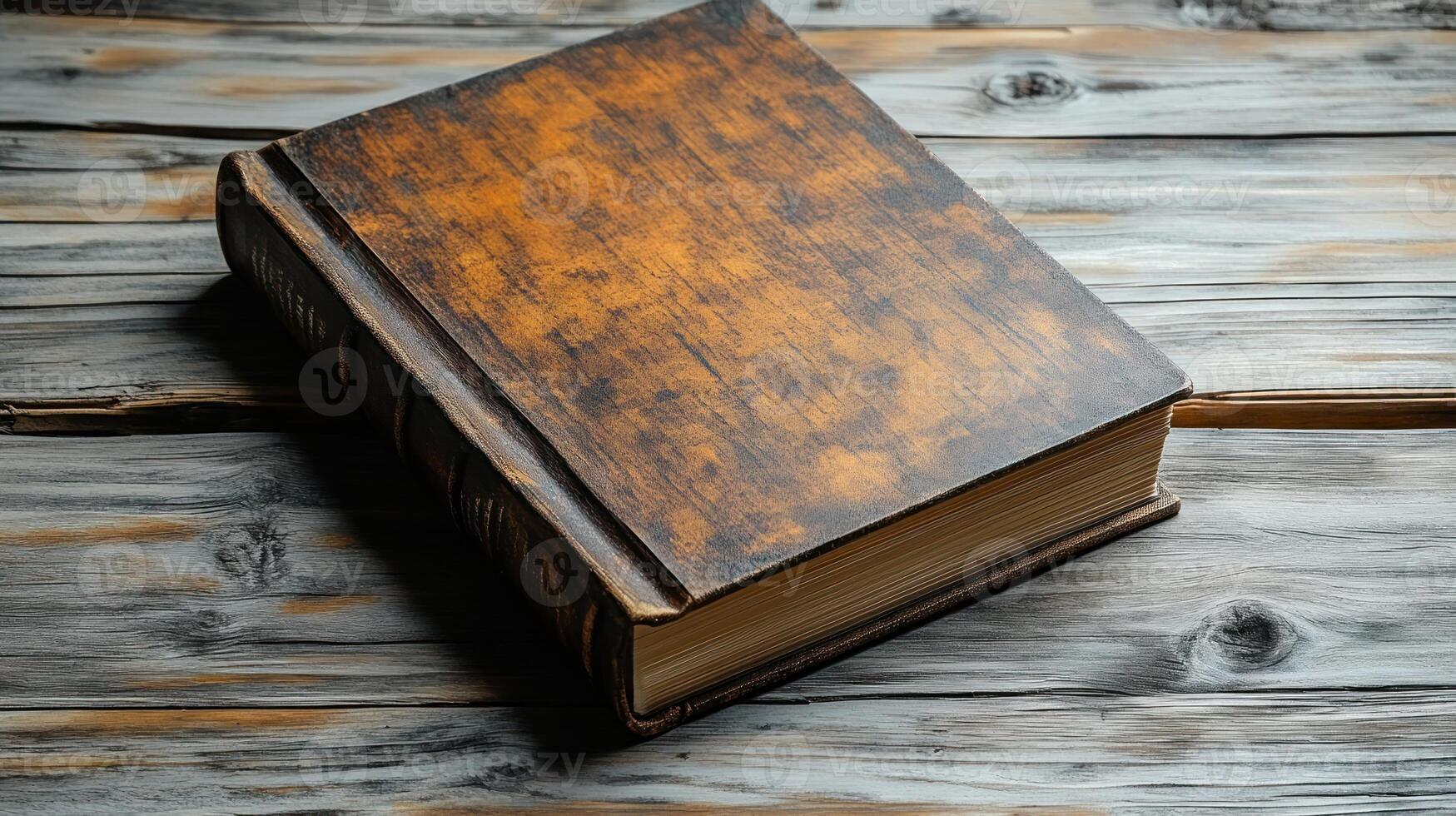 A beautifully aged book lies open on weathered wooden planks photo