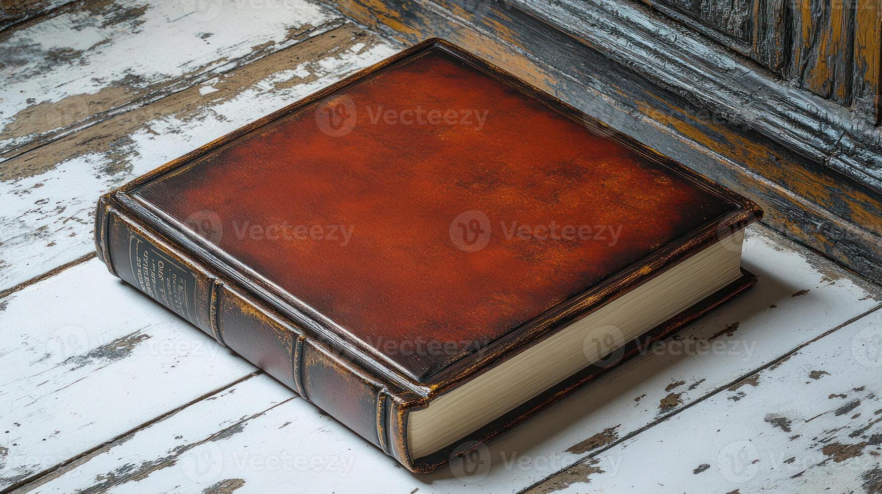 A classic leather-bound book lies on rustic wooden planks, inviting discovery photo