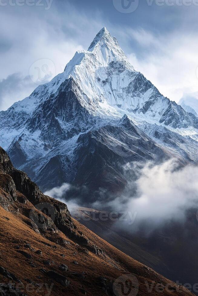 Majestic mountain peaks rise above mist-covered valleys under soft morning light in tranquil wilderness photo