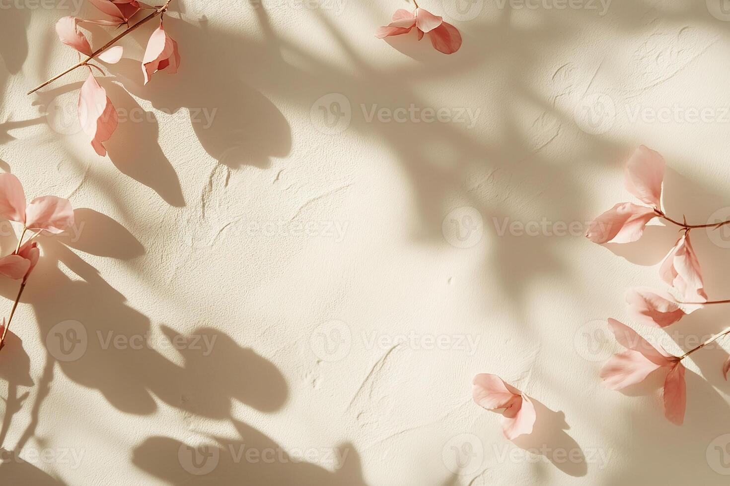 Elegant blush petals scattered on a smooth cream surface creating a serene and feminine atmosphere with soft shadows and ample space for text overlay photo