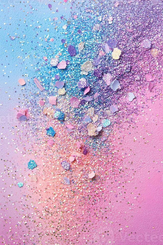 Scattered glittery eyeshadow pigments create a magical pastel wonderland on a soft rainbow gradient background with ample space for text overlay photo