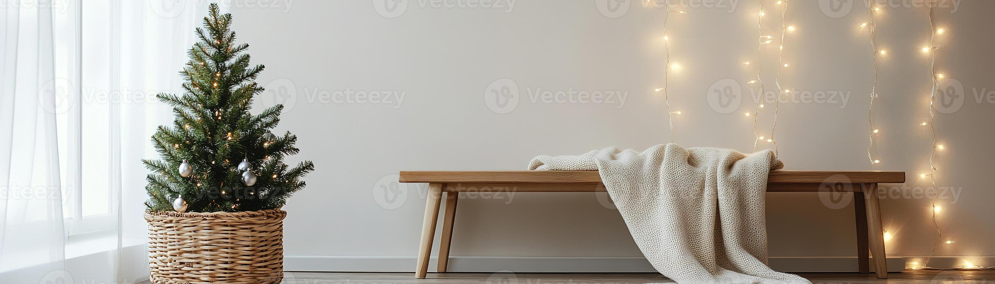 A cozy living room is decorated for Christmas with a small pine tree in a wicker basket, soft string lights, and a wool blanket draped over a wooden bench, creating a calm atmosphere photo