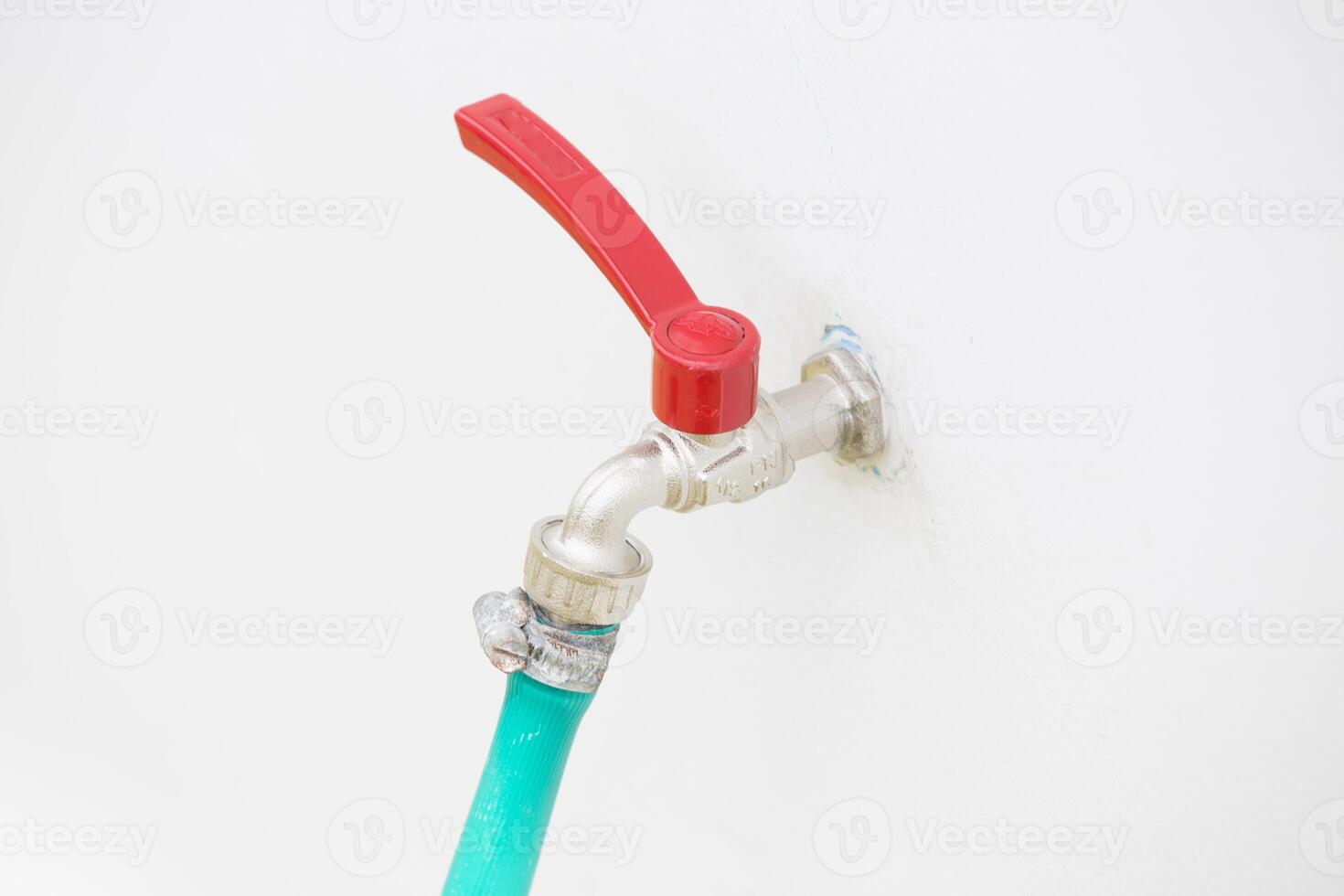 Faucets with hose green on concrete wall. photo