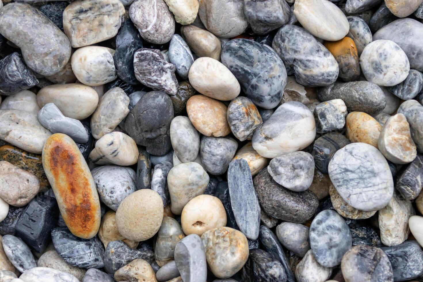 Colorful pebbles on the beach as a background texture composition photo