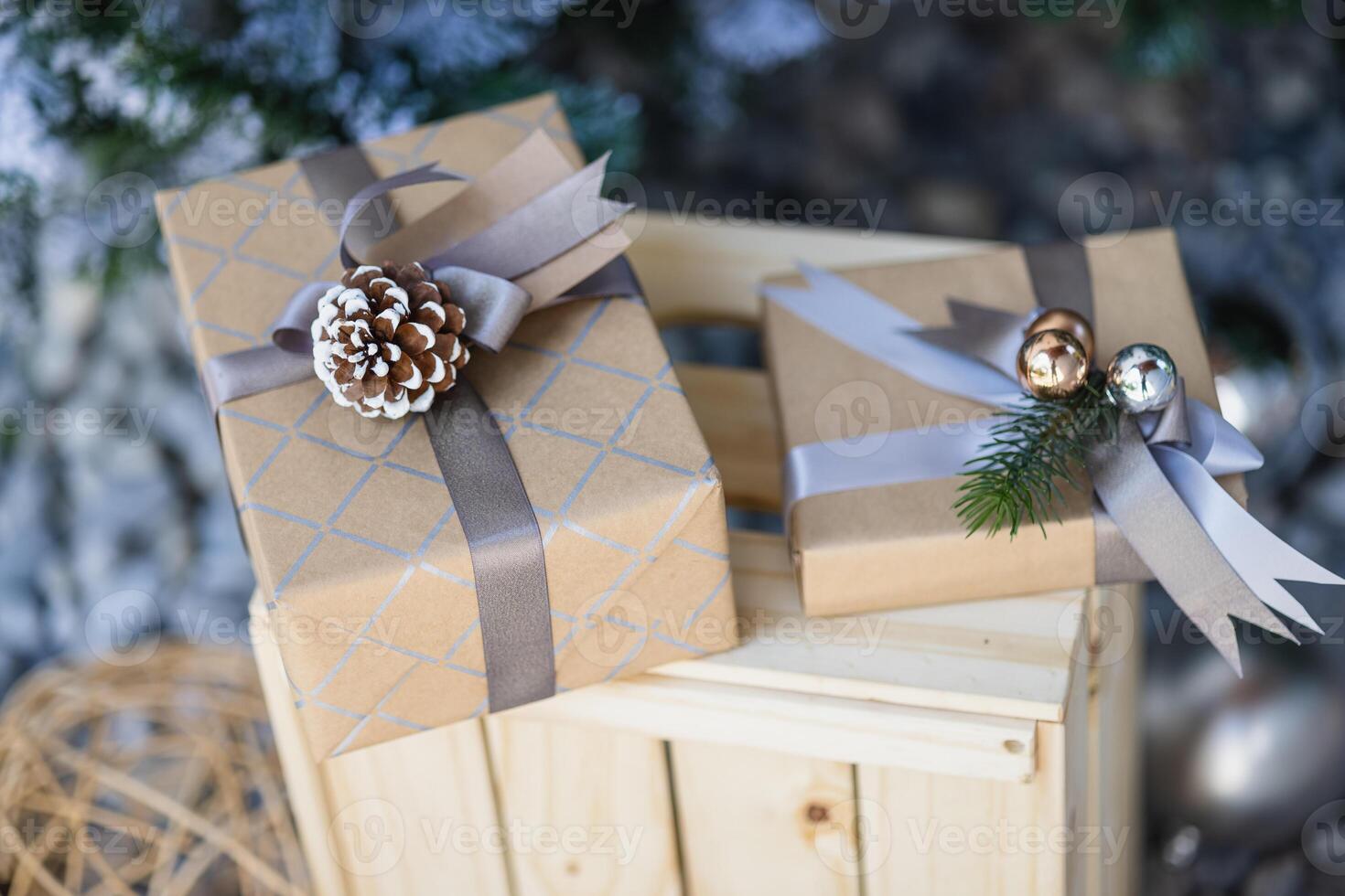 Gift boxes with ribbon and bow on the background of Christmas tree photo