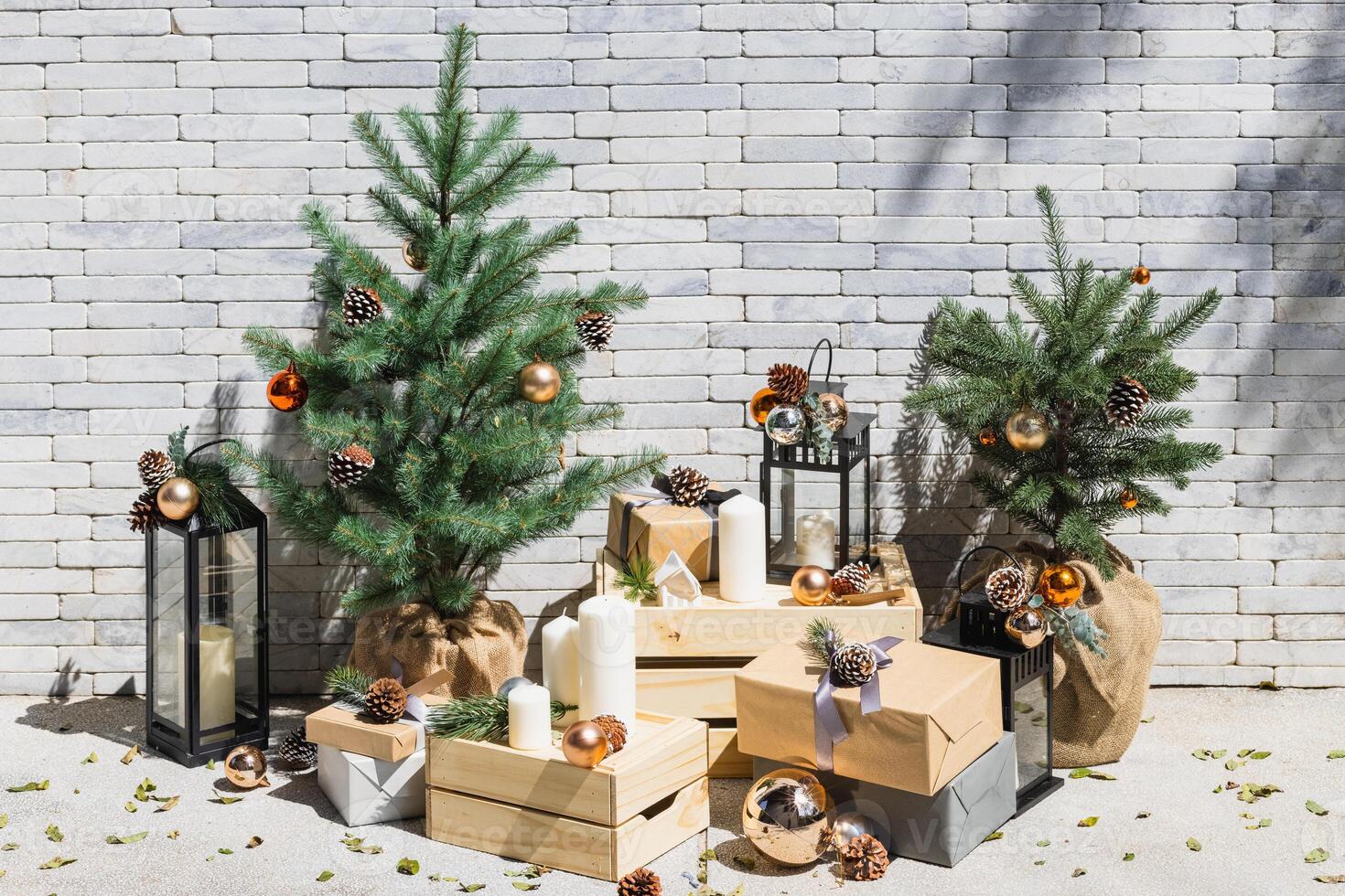 Christmas tree and gifts on the background of a brick wall with copy space photo