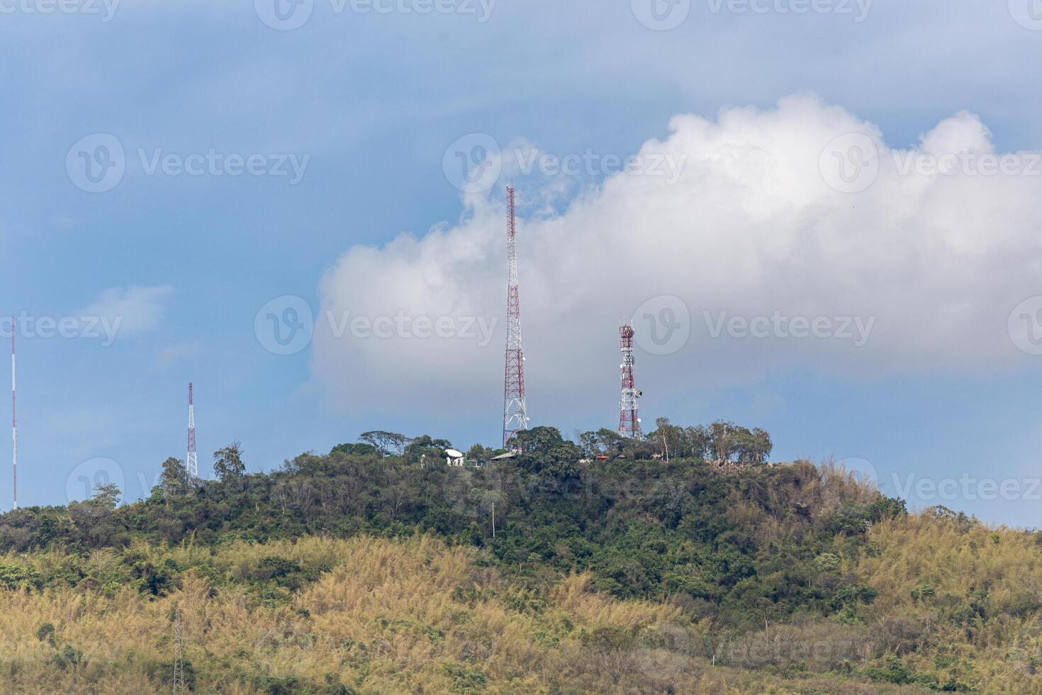 Telecommunication tower on the mountain with blue sky background, Thailand. photo