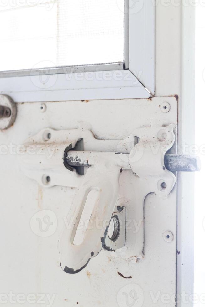 Close-up of the door handle of an old white car. photo