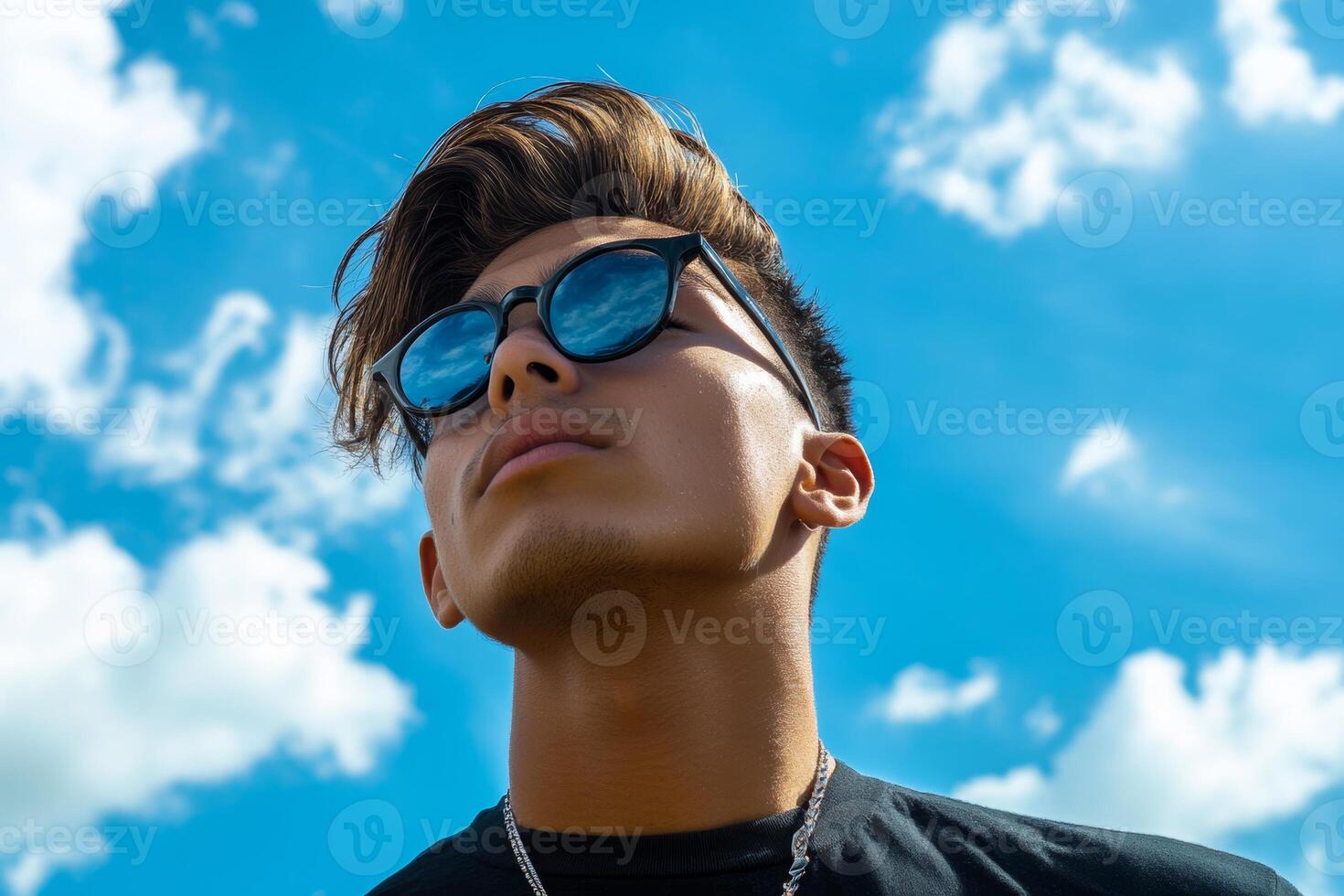 A man wearing sunglasses and a black shirt photo