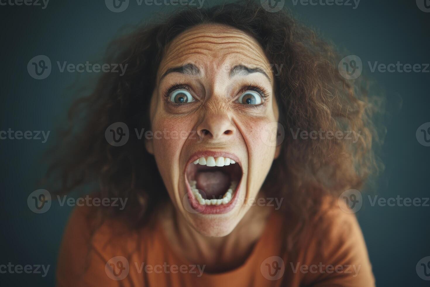 A woman with an open mouth and an angry expression photo