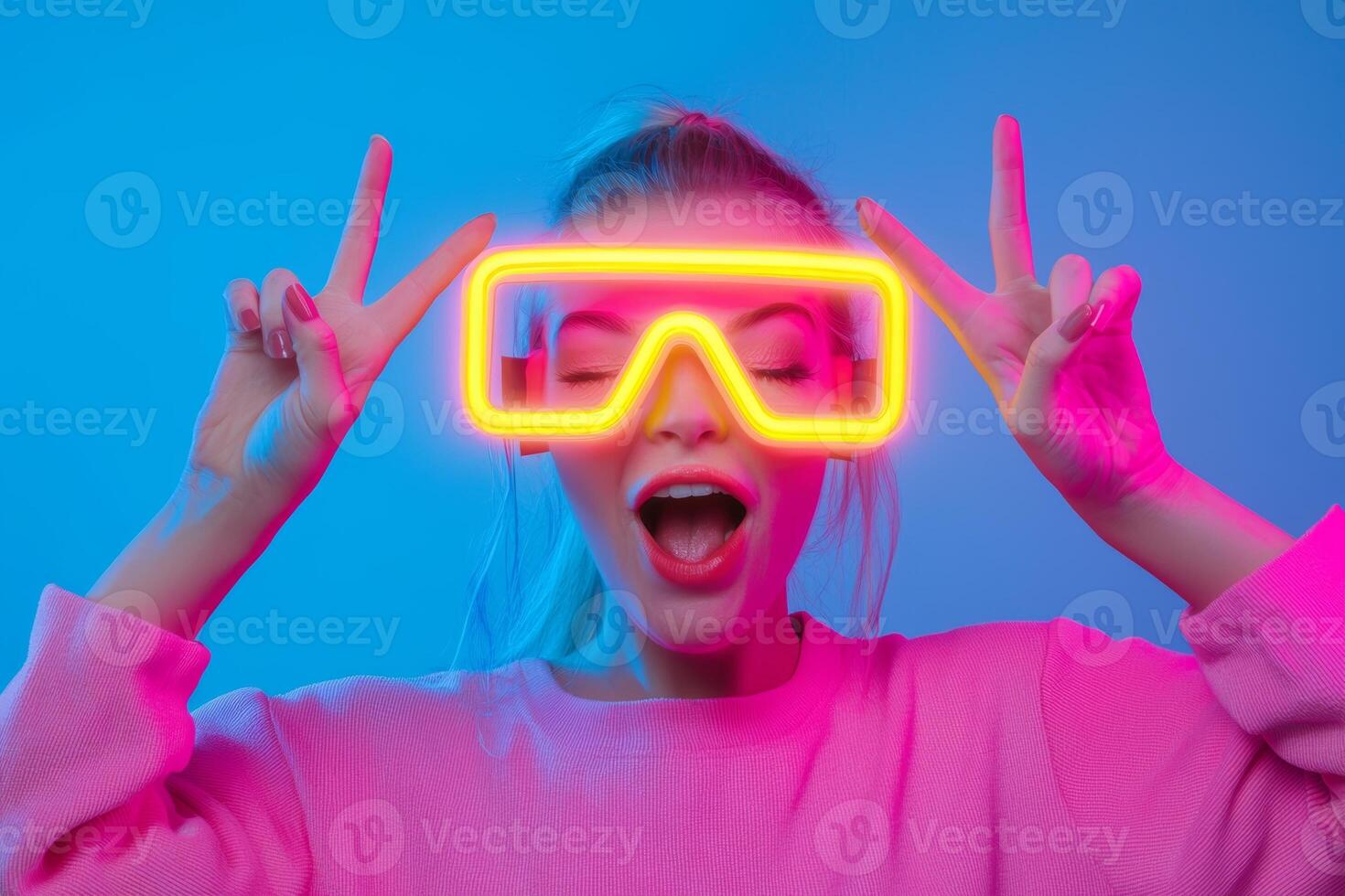 A young woman enjoys a vibrant party atmosphere wearing neon glasses and posing playfully against a colorful background photo