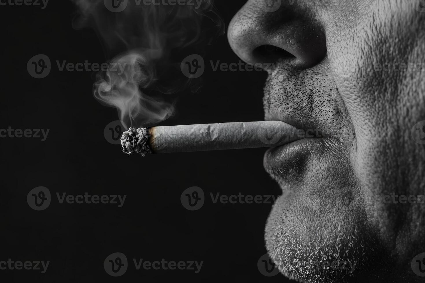 A close-up view of a man smoking a cigarette, capturing the smoke and facial details in stark monochrome lighting photo