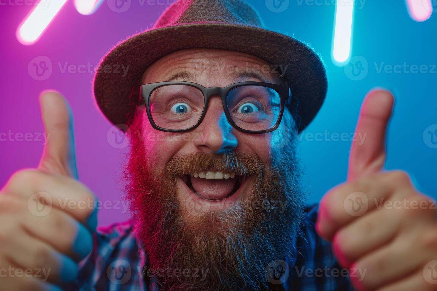 A joyful man expresses excitement with a big smile and thumbs up, wearing glasses and a hat, surrounded by colorful neon lights in a lively setting. photo