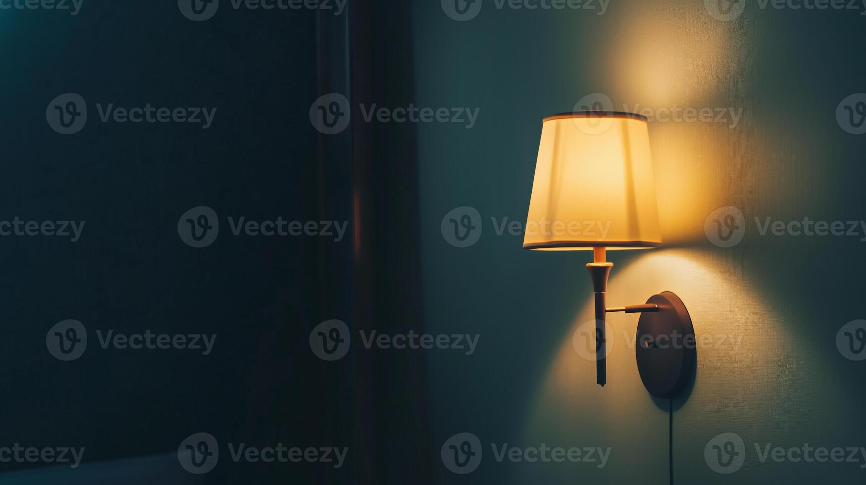 Close up shot of a night lamp next to a bed photo