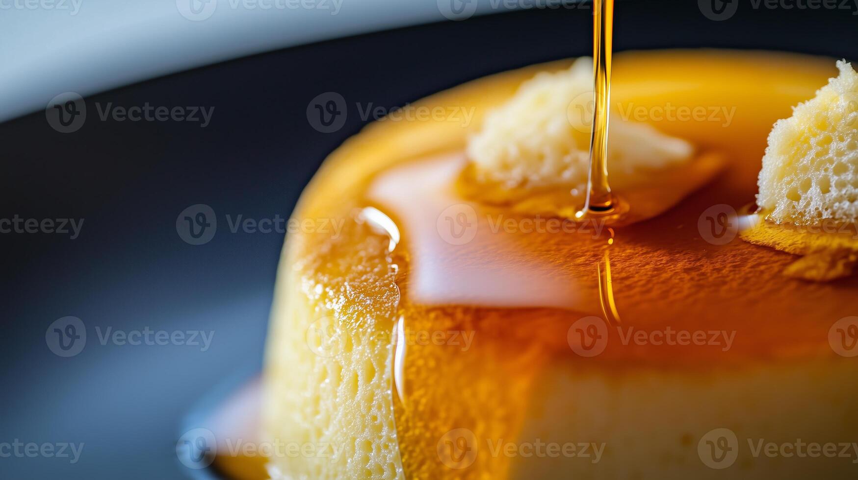 Close up of fluffy Japanese souffle pancake with maple syrup pouring over photo