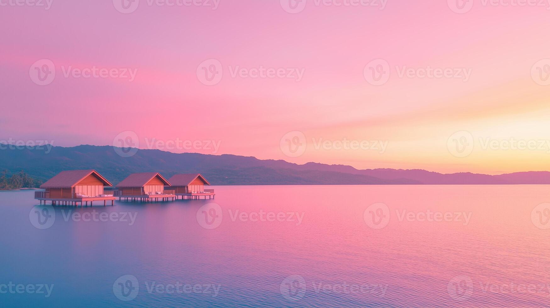 Tranquil Overwater Bungalows at Dusk with Vibrant Sunset Sky Reflecting on Calm Ocean Waters Under Pastel Sky photo