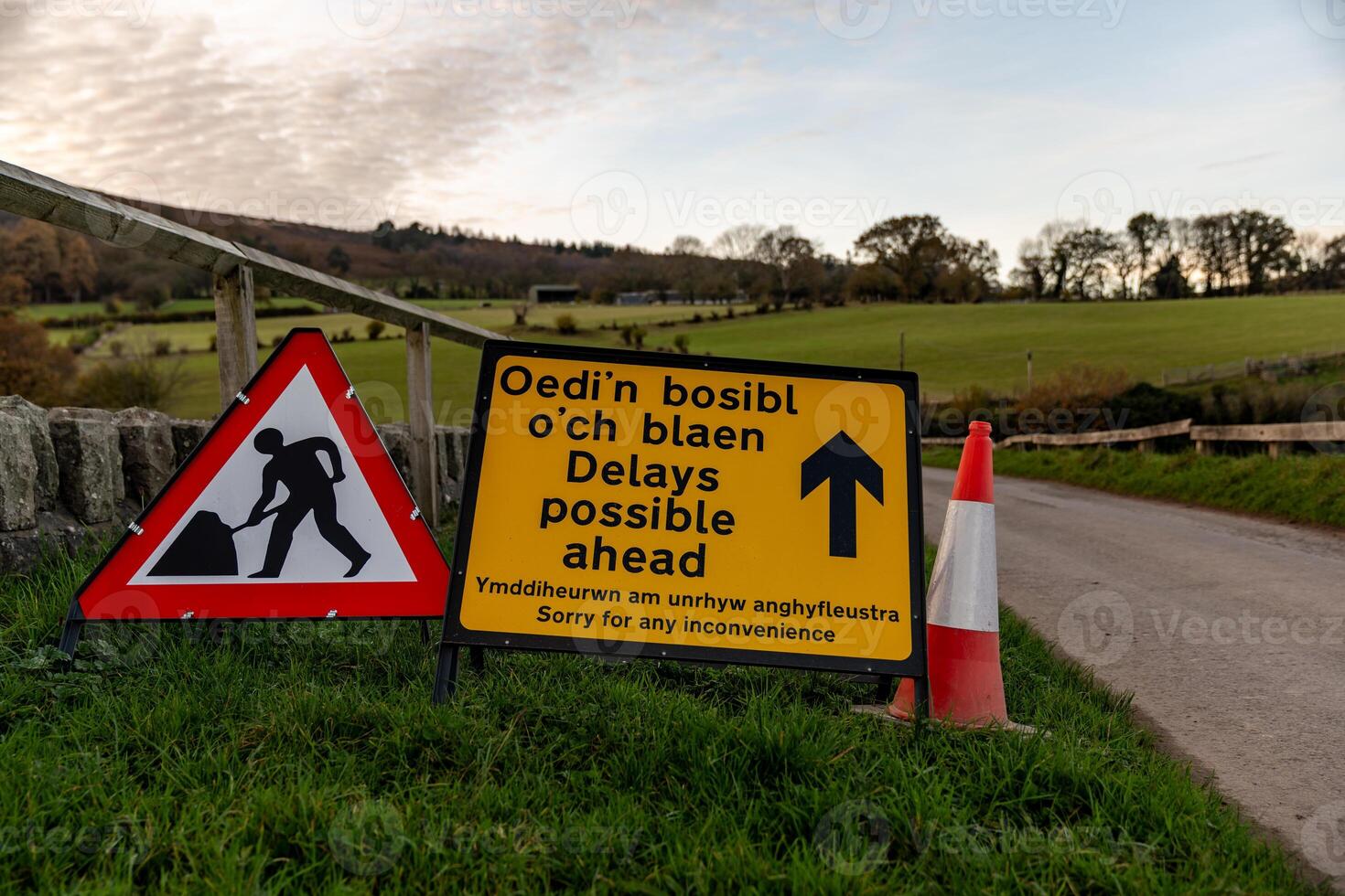 Road works sign announces possible delays in welsh and english languages photo