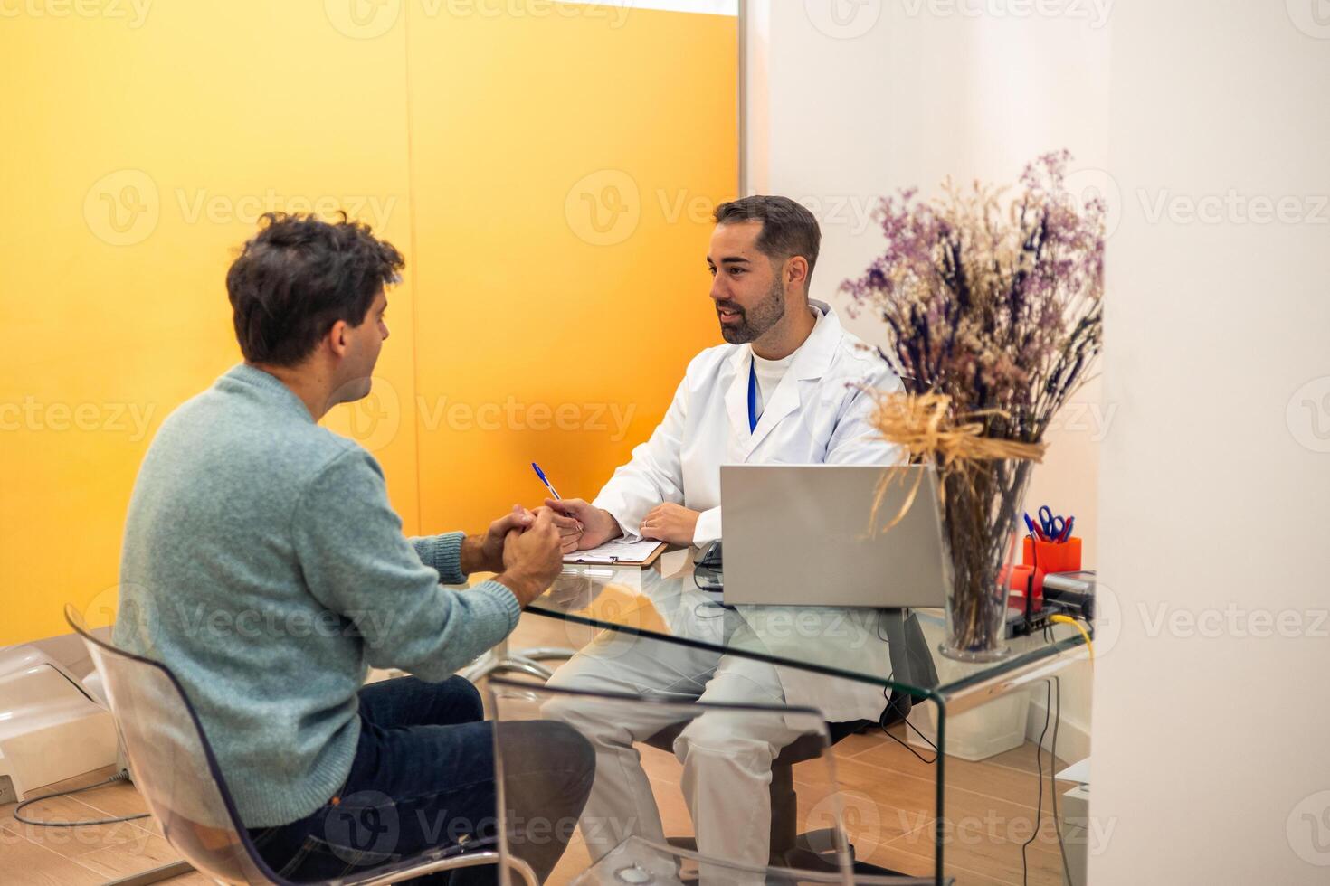 Dentist taking notes while talking with patient in modern clinic photo