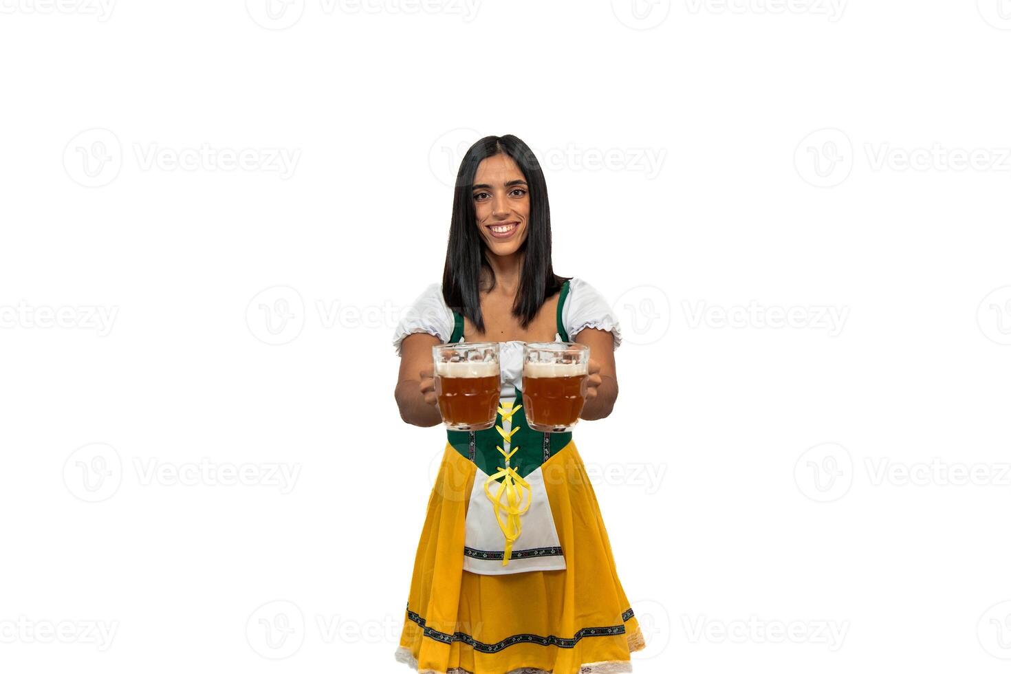 Smiling bavarian woman showing two cold beer glasses to camera in traditional oktoberfest attire photo