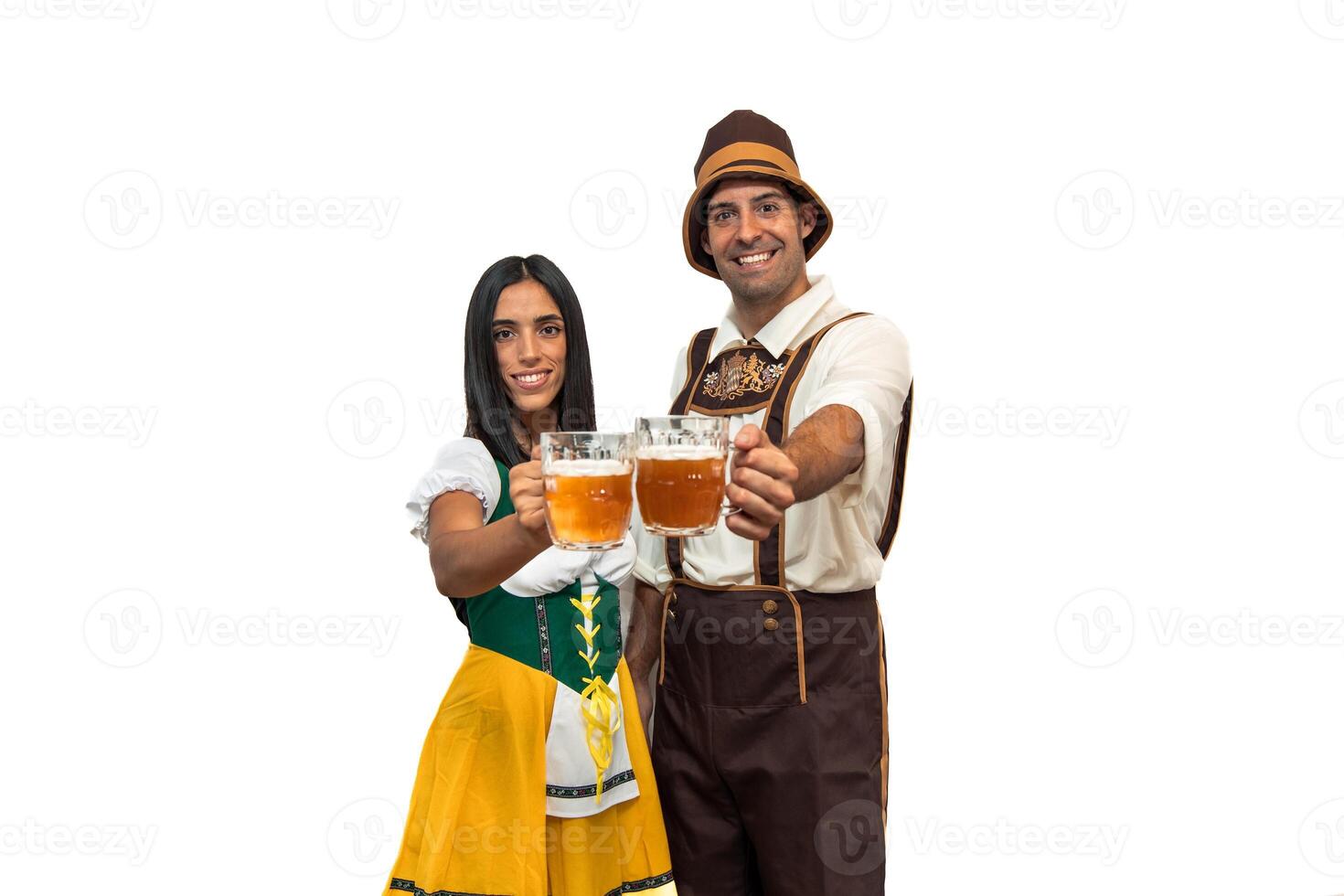 Young bavarian couple toasting towards camera with beer glasses during oktoberfest photo