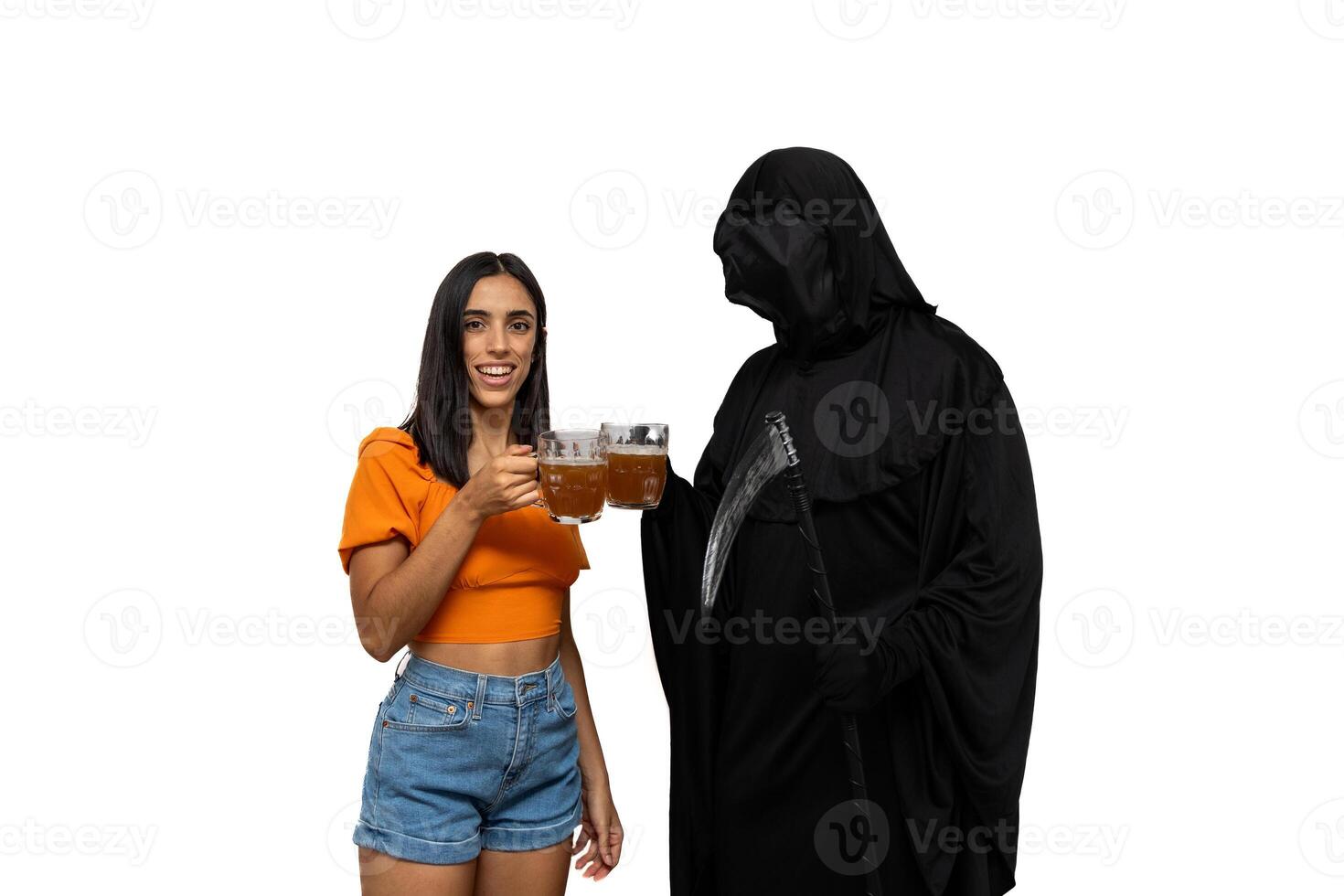 Grim reaper in Halloween costume holding scythe and toasting with beer alongside a young woman photo