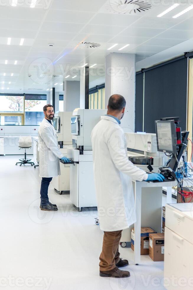 Scientists working with advanced equipment in modern bio laboratory photo