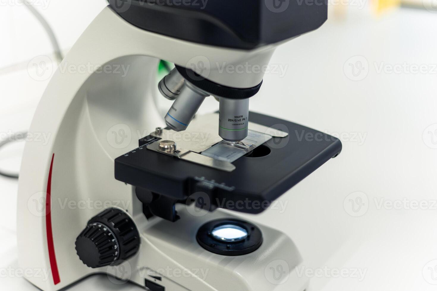 Modern microscope analyzing sample in scientific laboratory photo