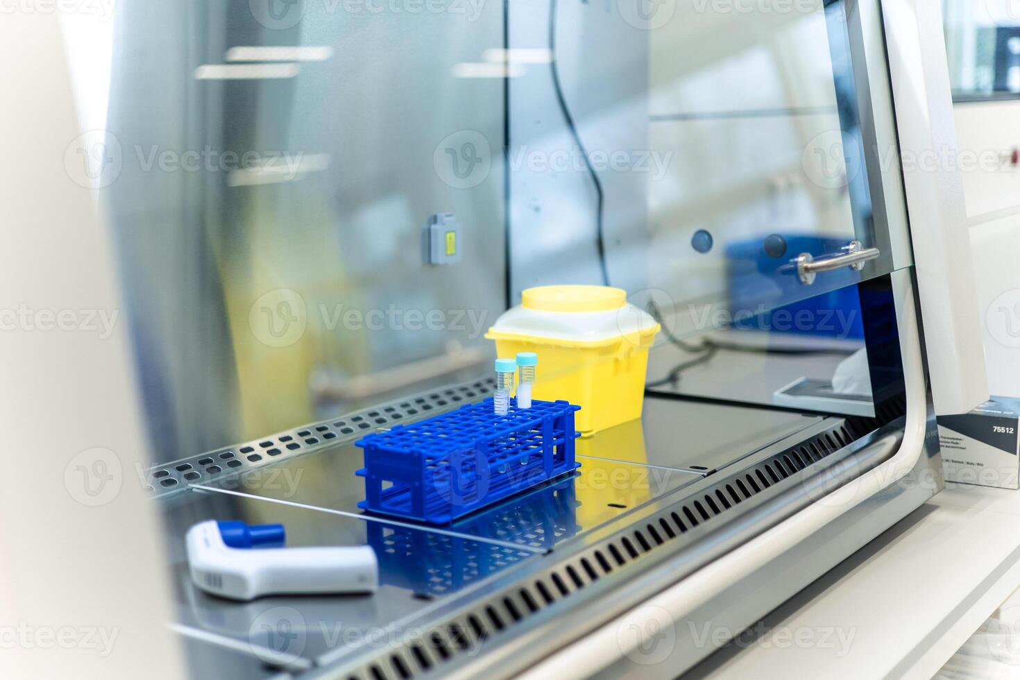Medical samples inside laminar flow cabinet waiting for analysis photo