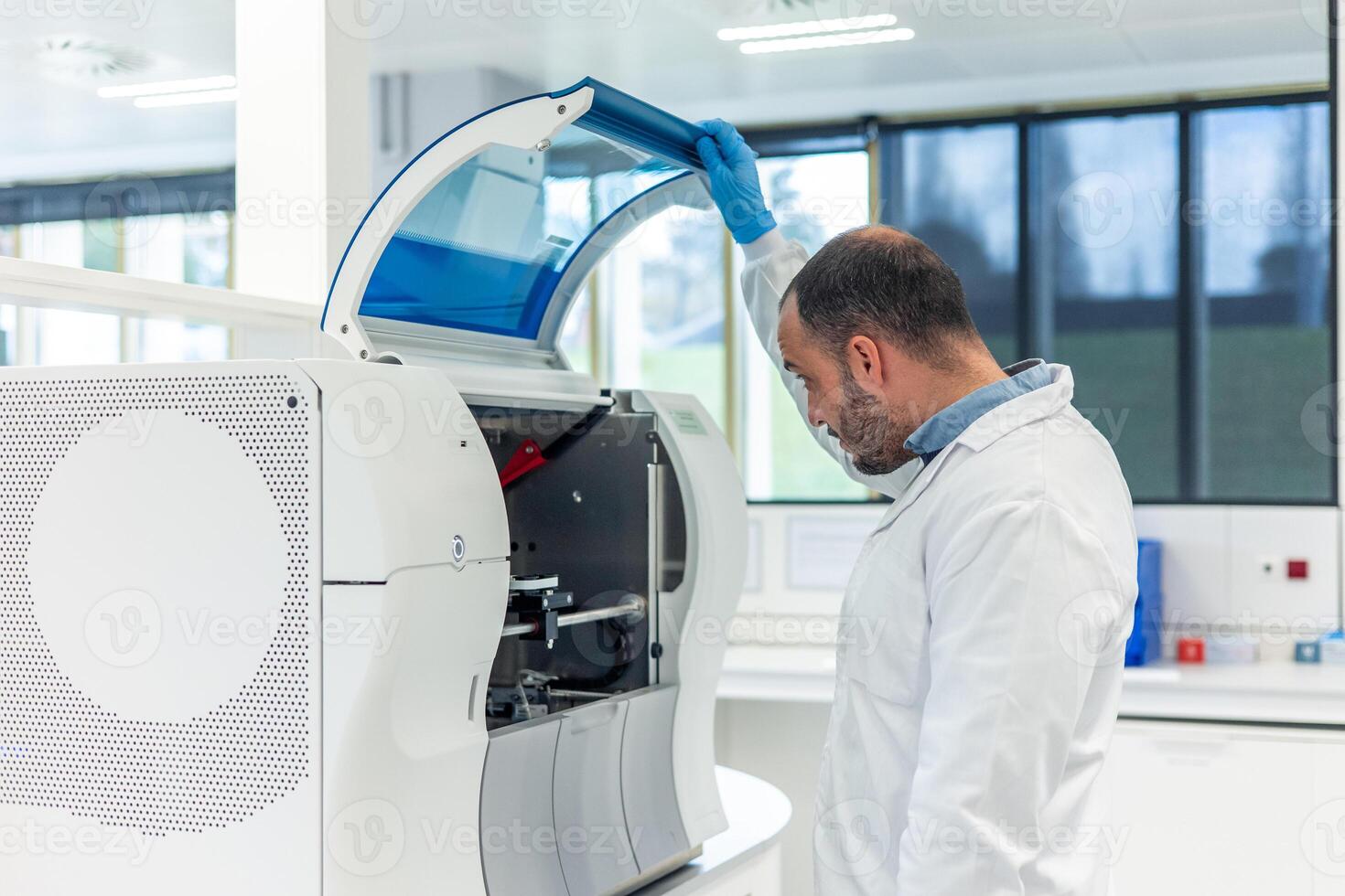 Scientist opening laboratory equipment for medical research photo