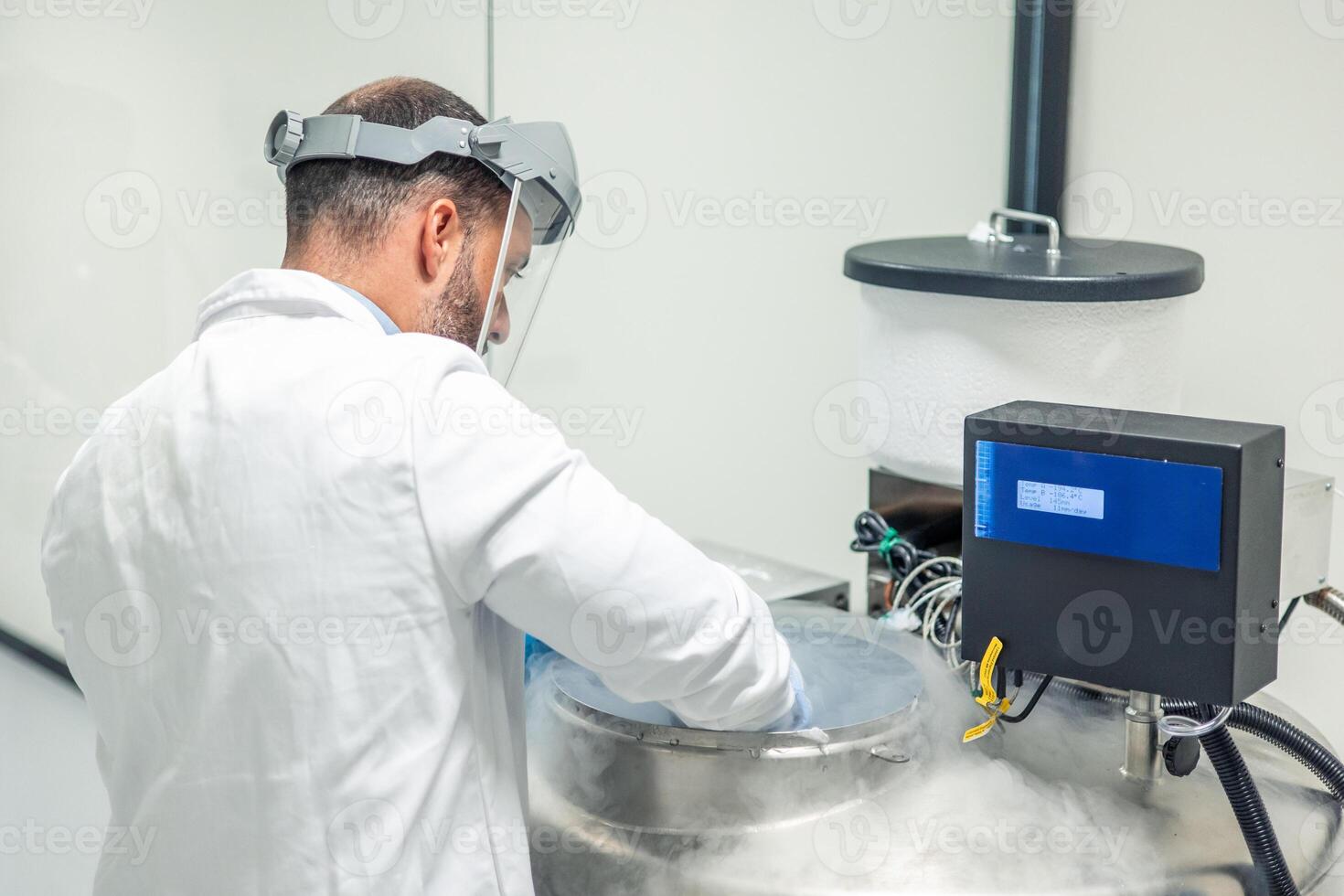 Scientist working with liquid nitrogen tank in a bio laboratory photo