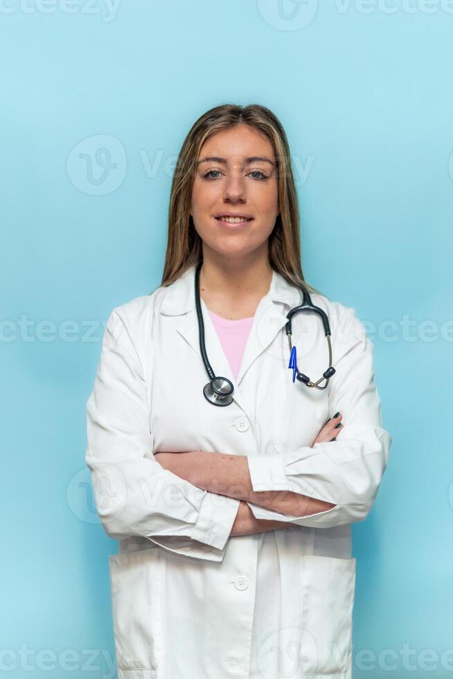 vertical Portrait of smiling doctor woman wearing stethoscope and lab coat posing with crossed arms photo