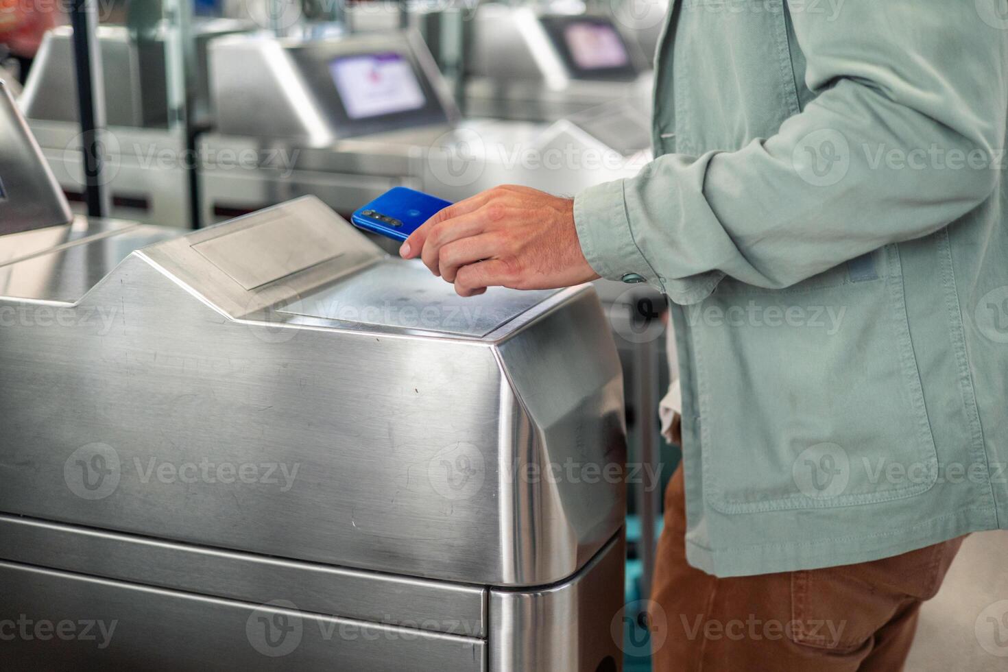 latin Tourist using smartphone to validate electronic ticket at subway station entrance photo