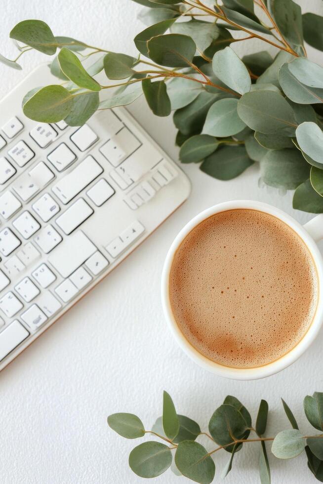Calm workspace with coffee cup and eucalyptus leaves on a clean desk setting photo