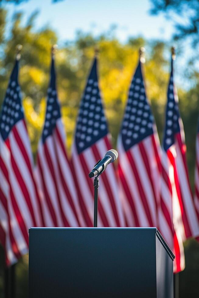 Mic in front of multiple American flags at a public event setting during daytime photo