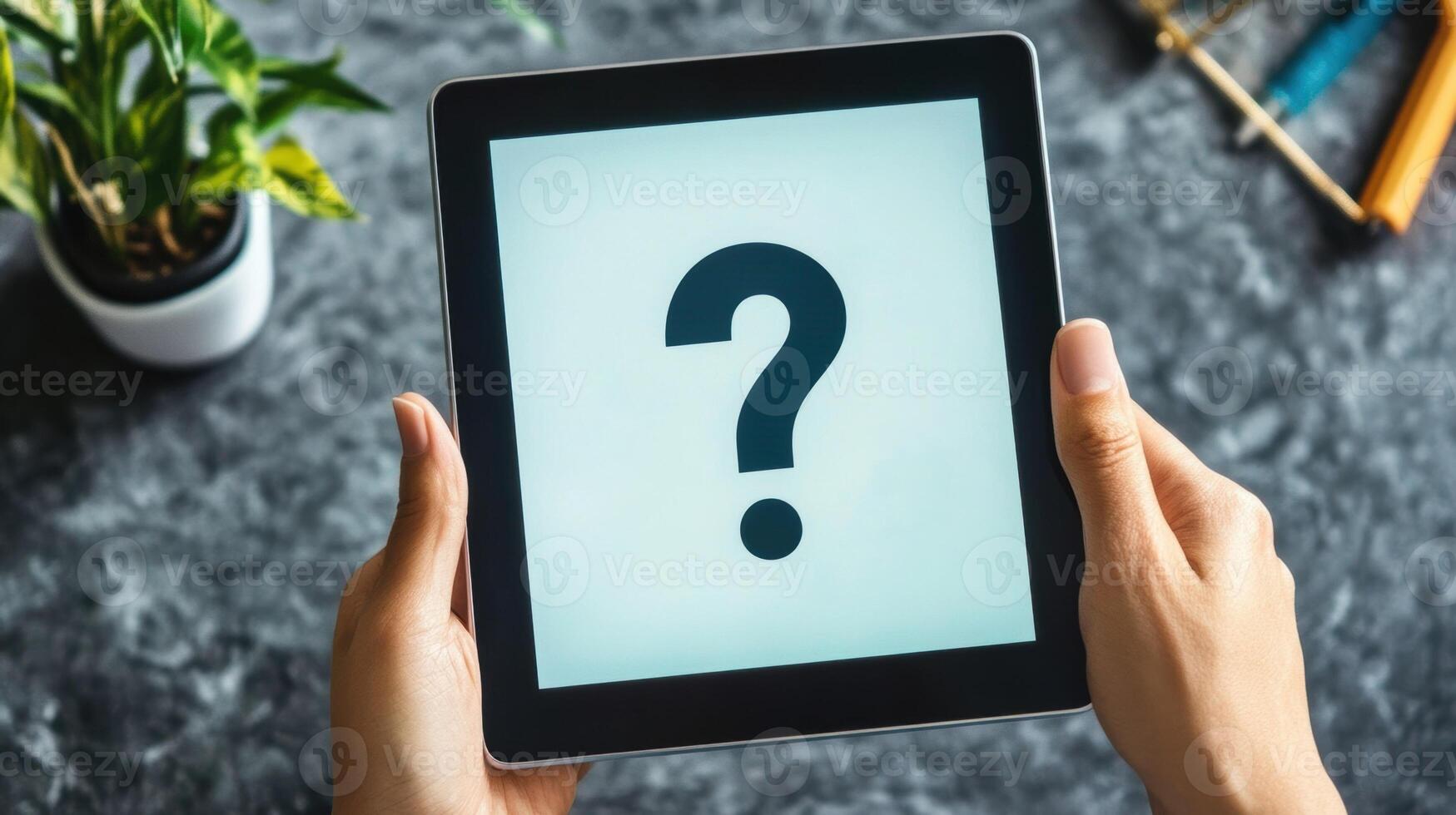 Hands holding digital tablet showing question mark on screen photo