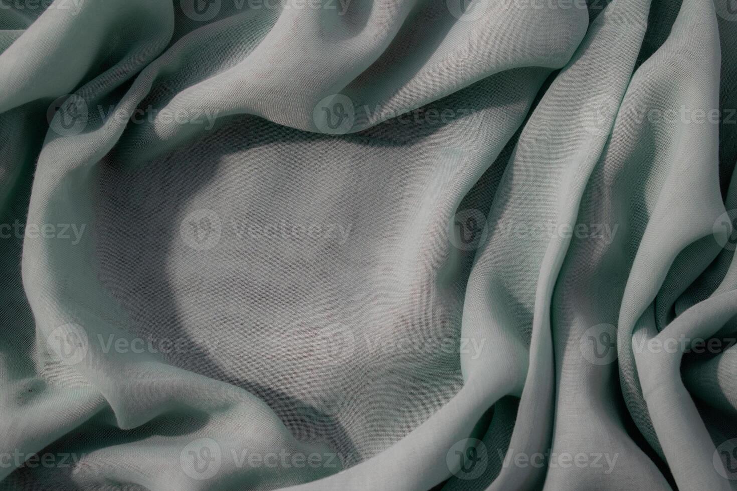 background texture wavy crumpled Nude green fabric with copy space. photo