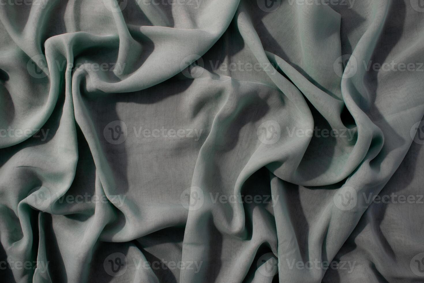 wavy crumpled Nude green fabric background texture with copy space. photo