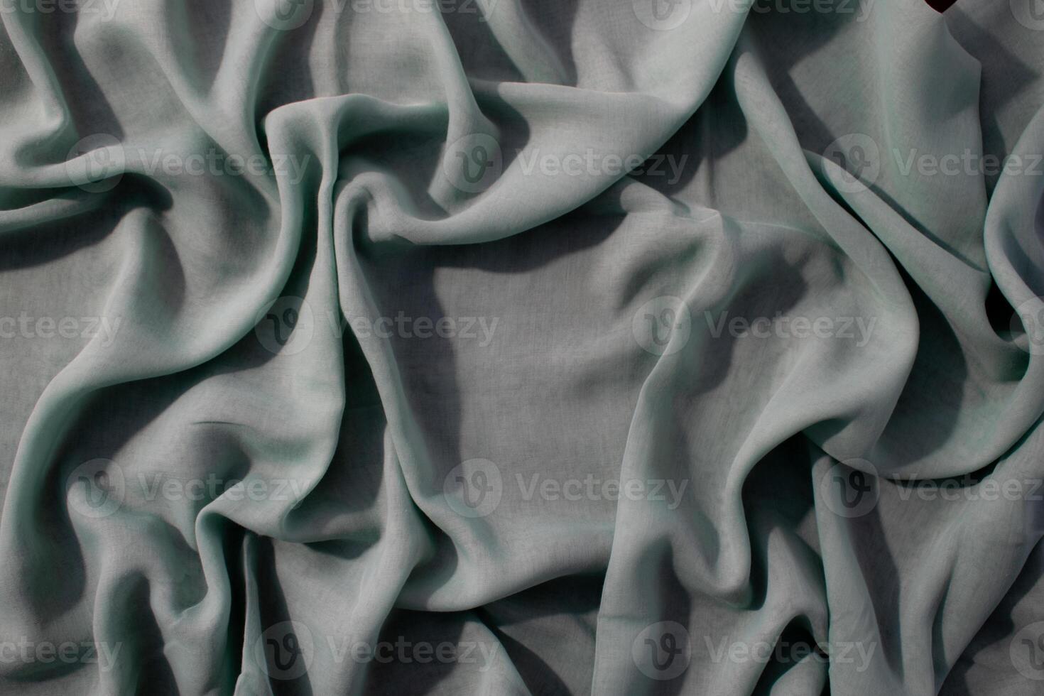 wavy crumpled abstract background texture Nude green fabric with copy space. photo