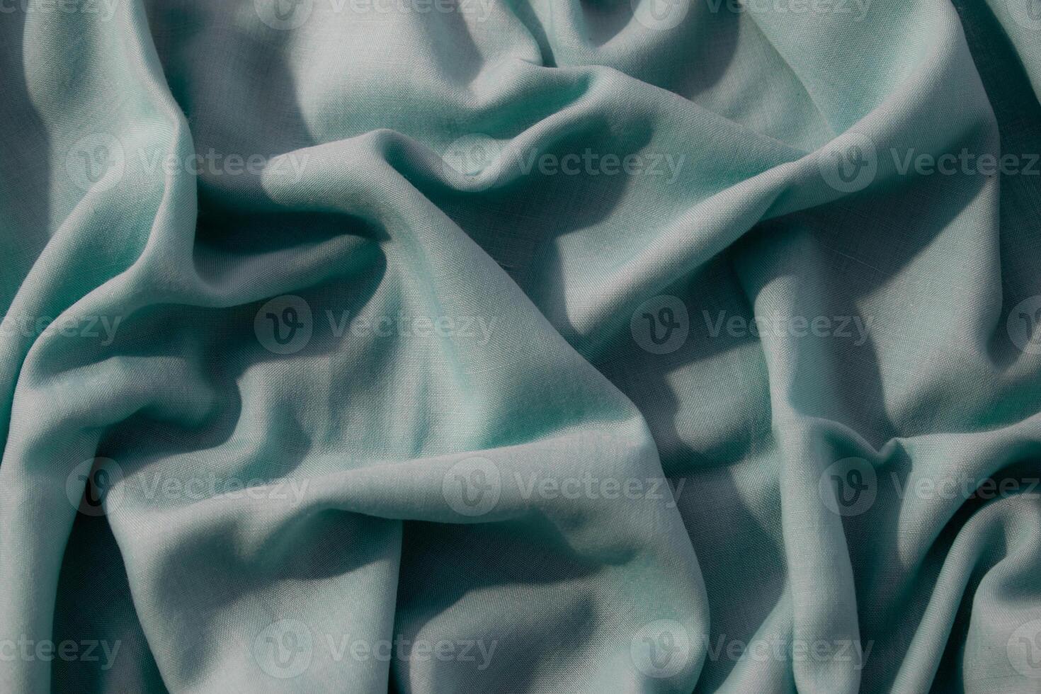 wavy crumpled background texture Nude green fabric with copy space. photo