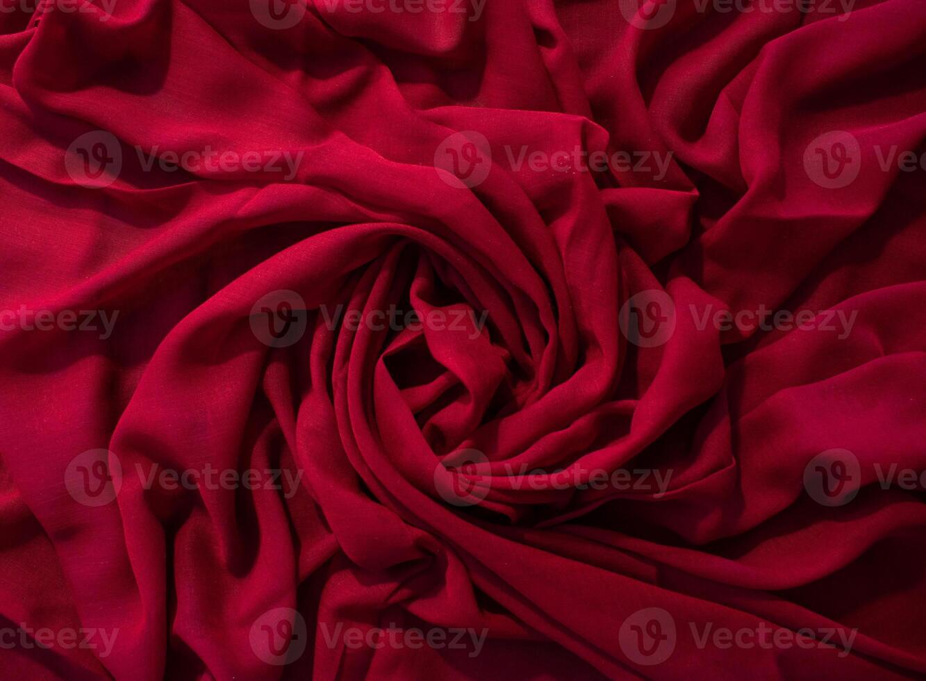 abstract background texture Red fabric wavy spiral crumpled. photo