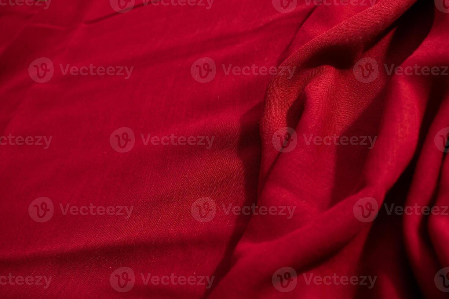 abstract background Red fabric wavy crumpled texture with copy space. photo