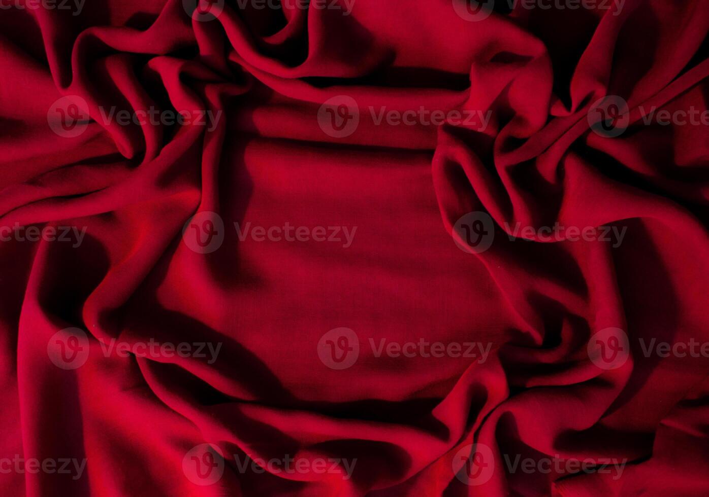 Red fabric wavy crumpled abstract background fabric texture with copy space. photo