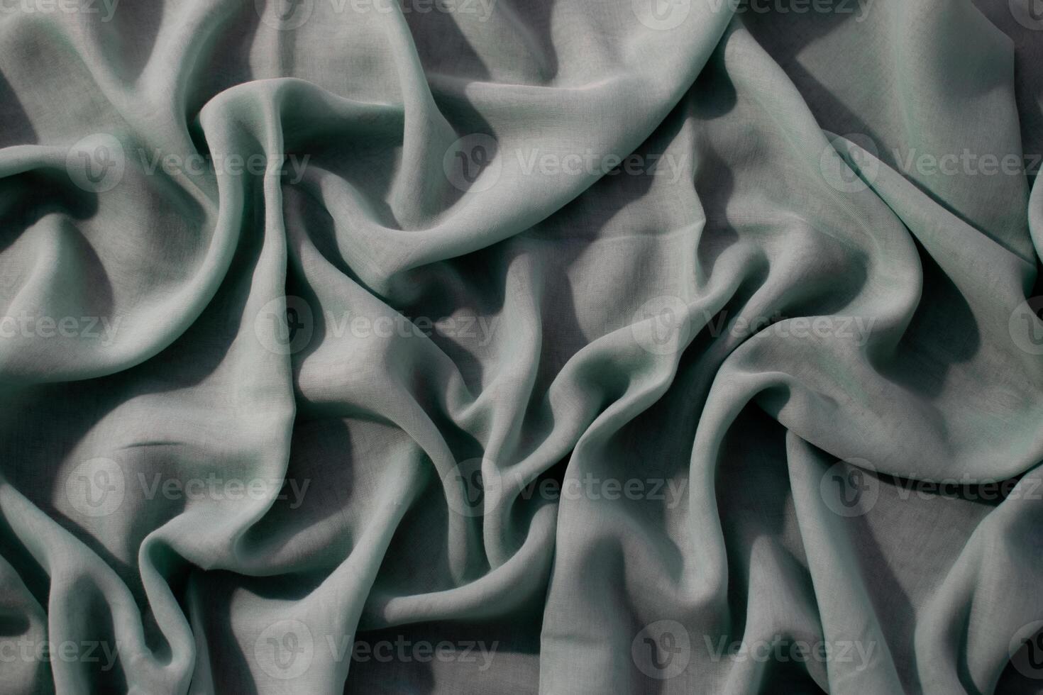Nude green wavy fabric crumpled background texture with copy space. photo