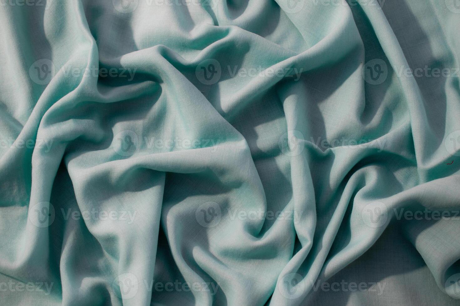 Nude green fabric crumpled background texture with copy space. photo